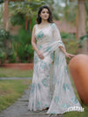 Off white organza saree with sea green floral motifs and delicate beadwork