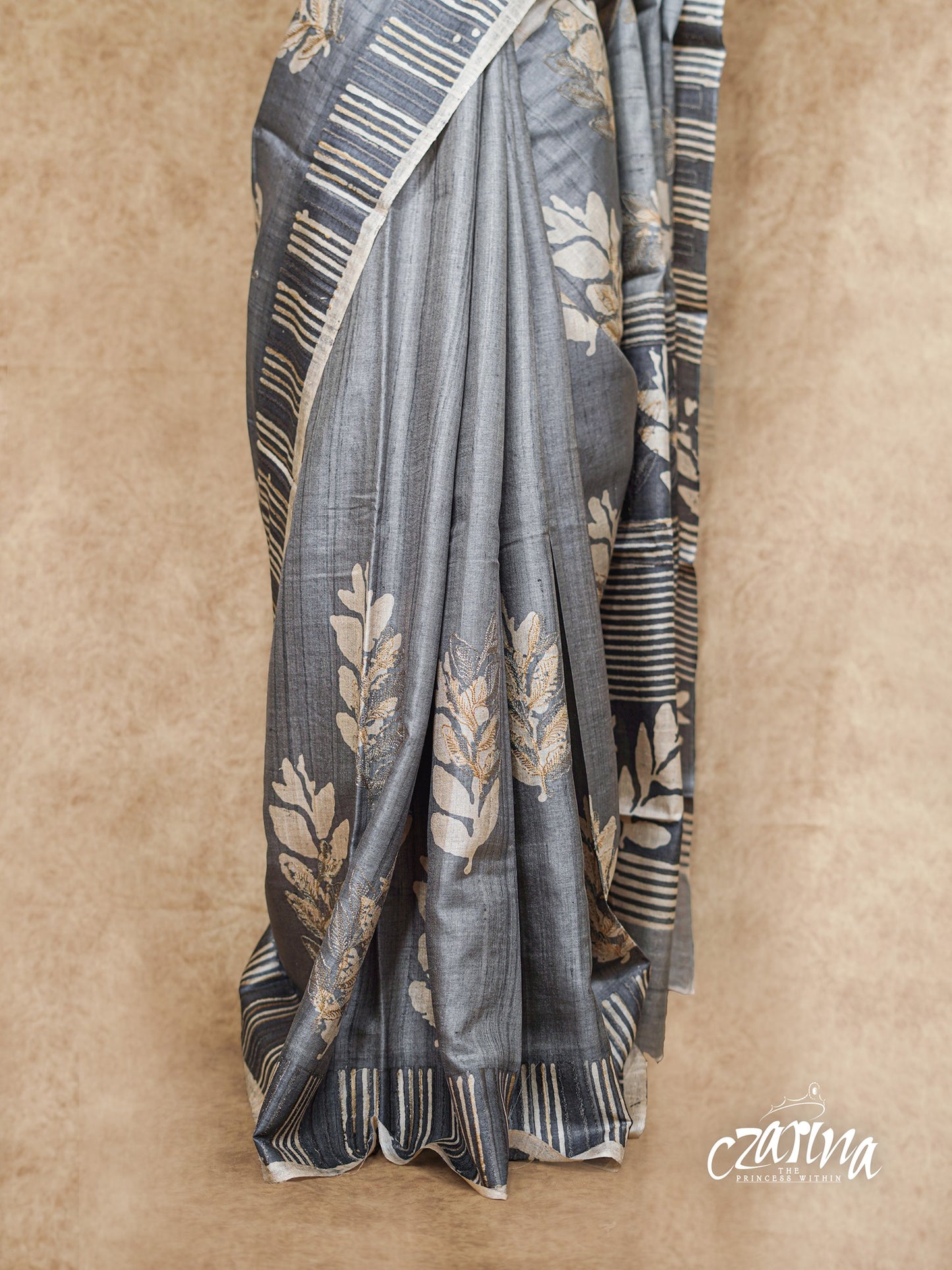 GREY PRINTED WITH WHITE LEAF DESIGNS AND EMBROIDERY HIGHLIGHTS TUSSAR SILK SAREE